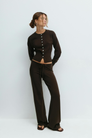 Brown knitted cardigan and trousers set on model, front view