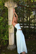 Mist blue corset top and wrap maxi skirt, side view against column