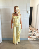 Yellow stripe halter top and trousers set, full length on model