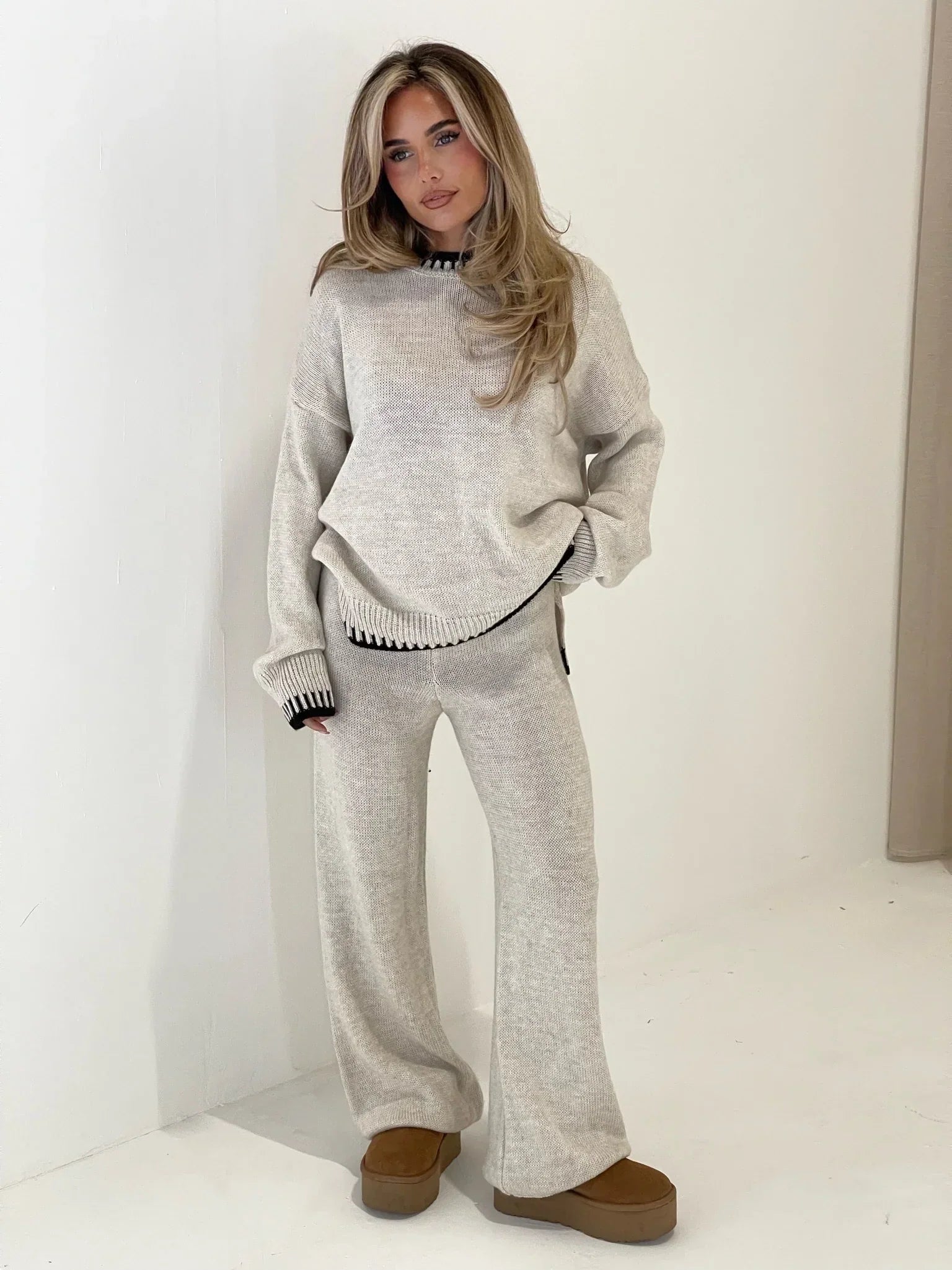 Grey knit jumper and trousers set, side view on model