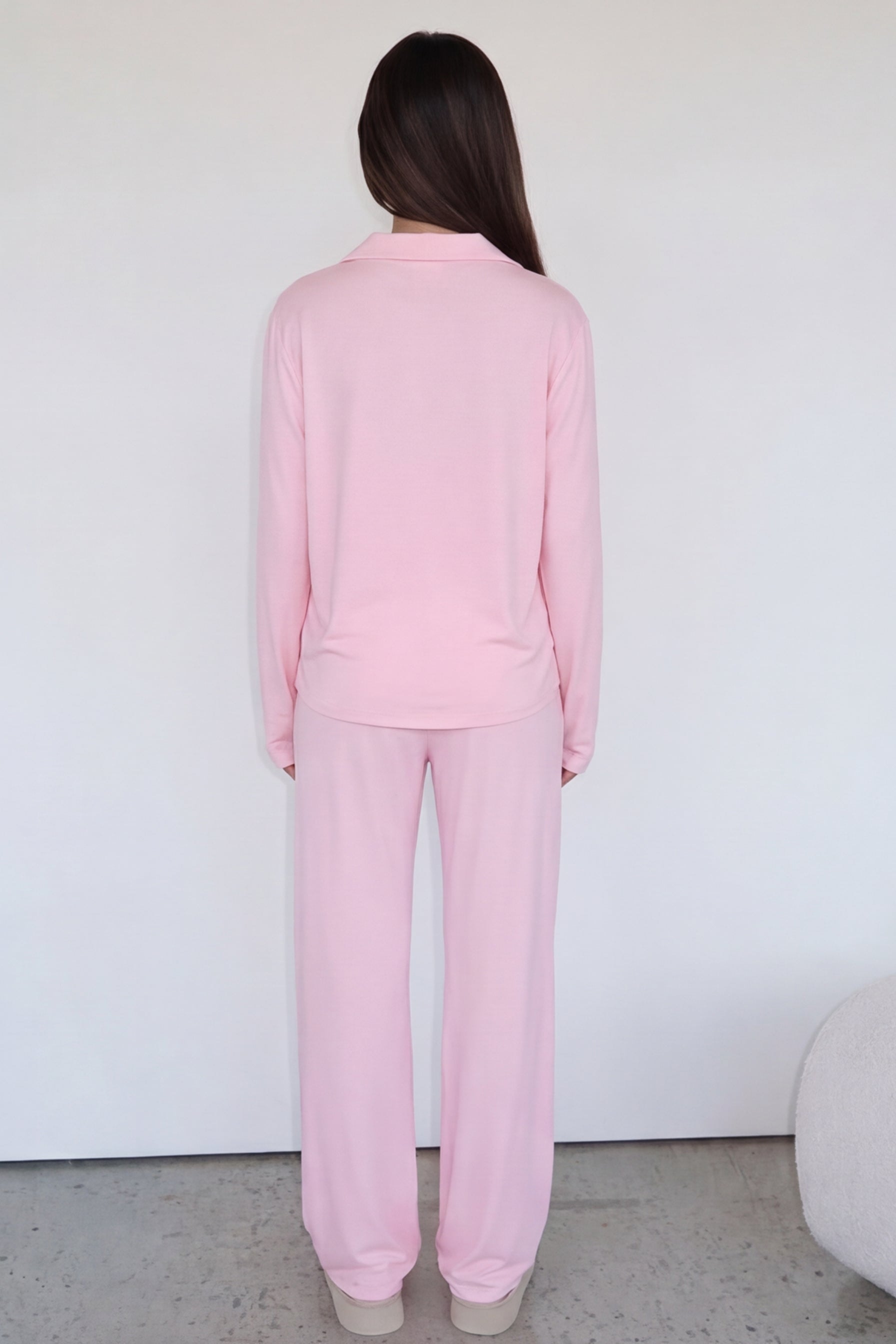 Pink long-sleeve pyjama set with trousers, back view on model