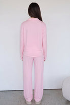 Pink long-sleeve pyjama set with trousers, back view on model