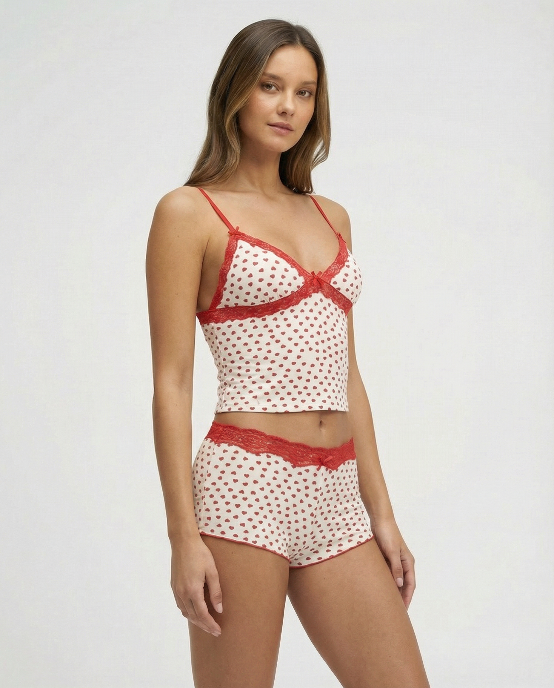 Ivory pyjama set with red heart print and lace trim, side view on model