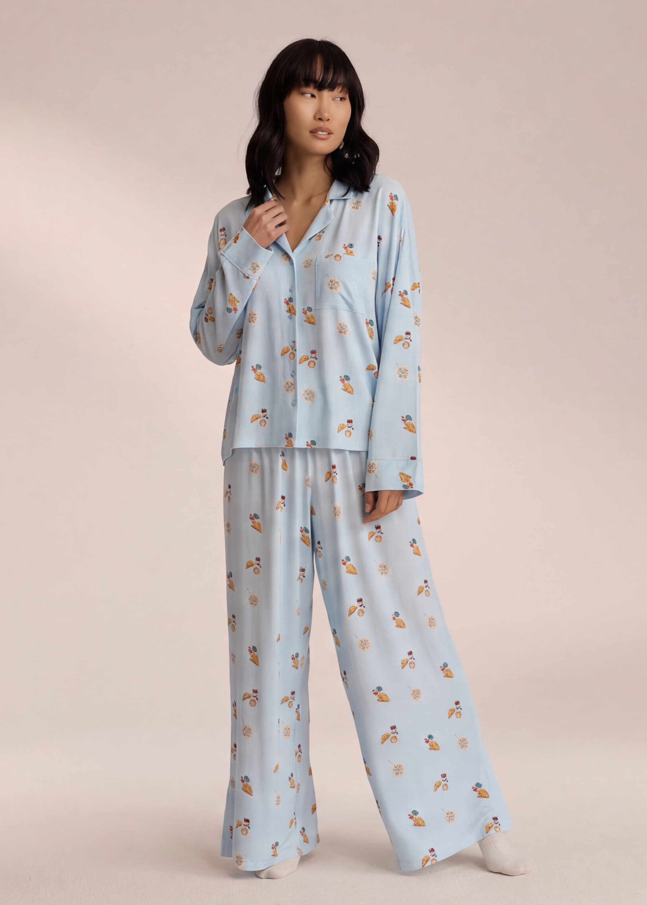 Light blue breakfast-print pyjama set with trousers, angled view