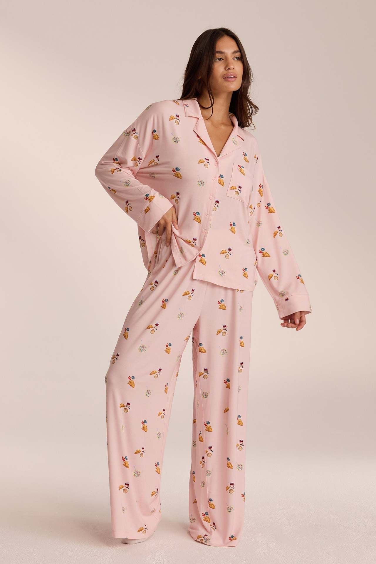 Pink breakfast-print pyjama set with trousers, front view on model