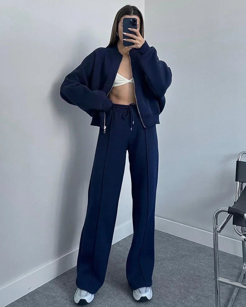 Dark blue zip-up jacket and joggers set, mirror selfie on model