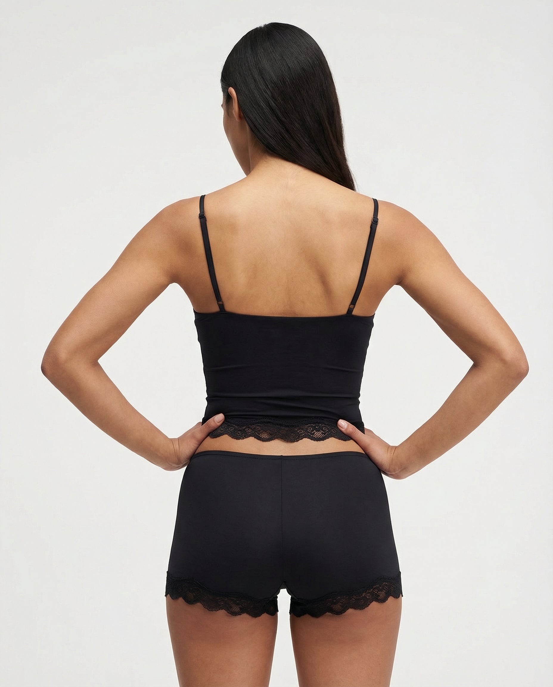 Black lace-trim pyjama set, cami and shorts, back view on model