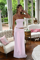 Blush pink corset top and wrap maxi skirt, front view in living room