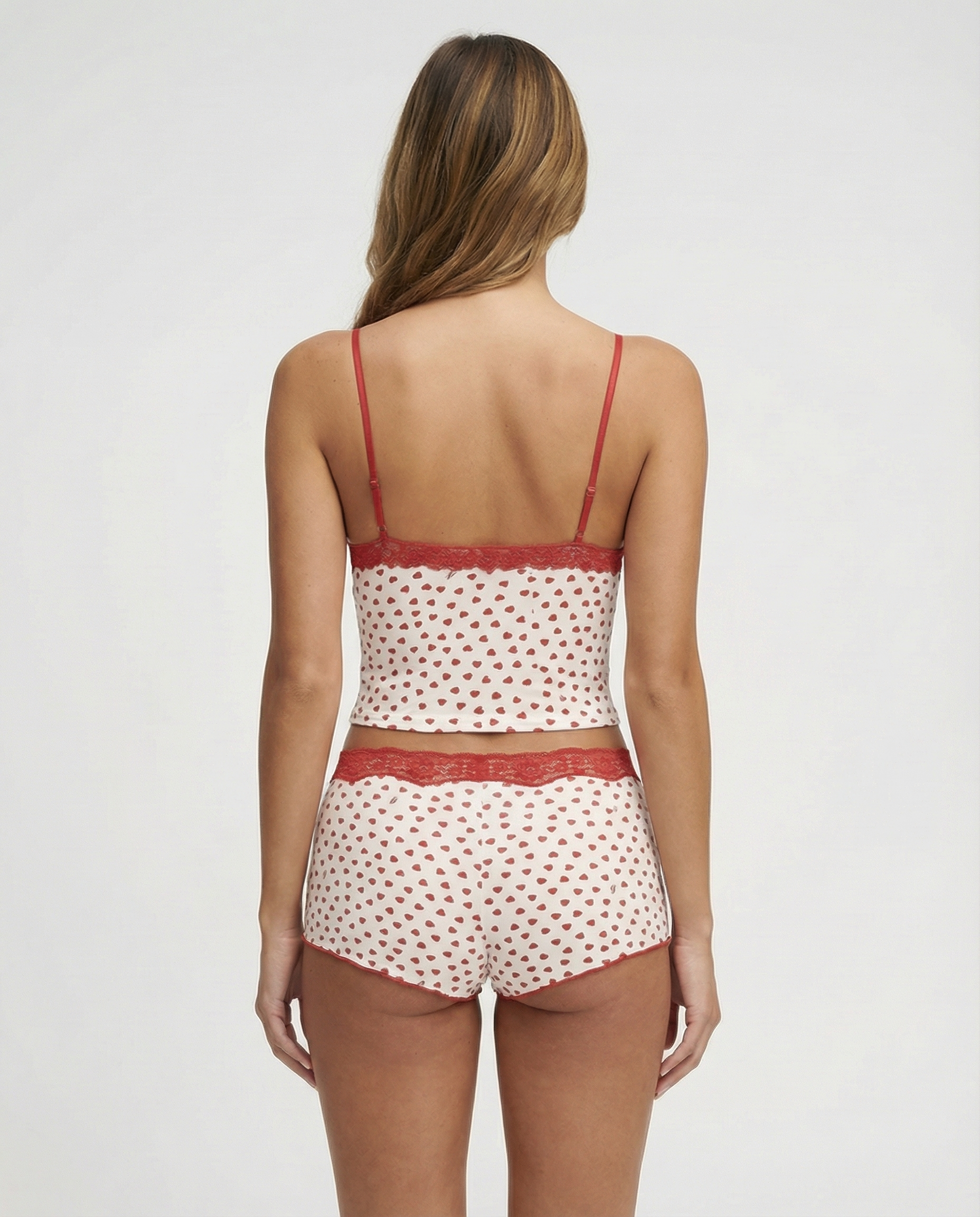 Ivory pyjama set with red heart print and lace trim, back view on model
