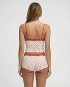 Ivory pyjama set with red heart print and lace trim, back view on model