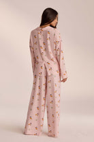 Pink breakfast-print pyjama set with trousers, back view on model