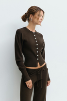 Close-up of brown knitted cardigan buttons on model