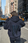 Navy hoodie and joggers with tonal sequin wings, back view on model