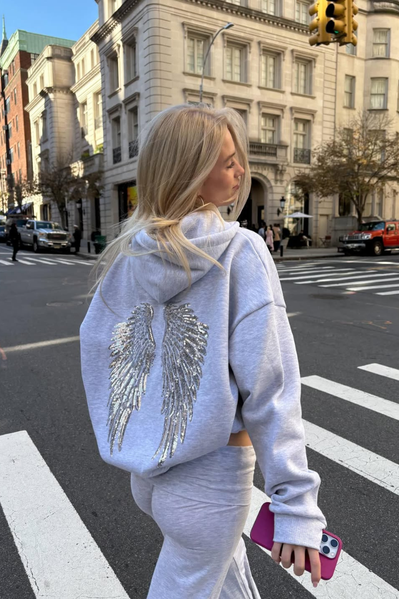 Close-up of sequin angel wings on grey hoodie, back view