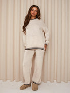 Beige knit jumper and trousers set with contrast trim, front view