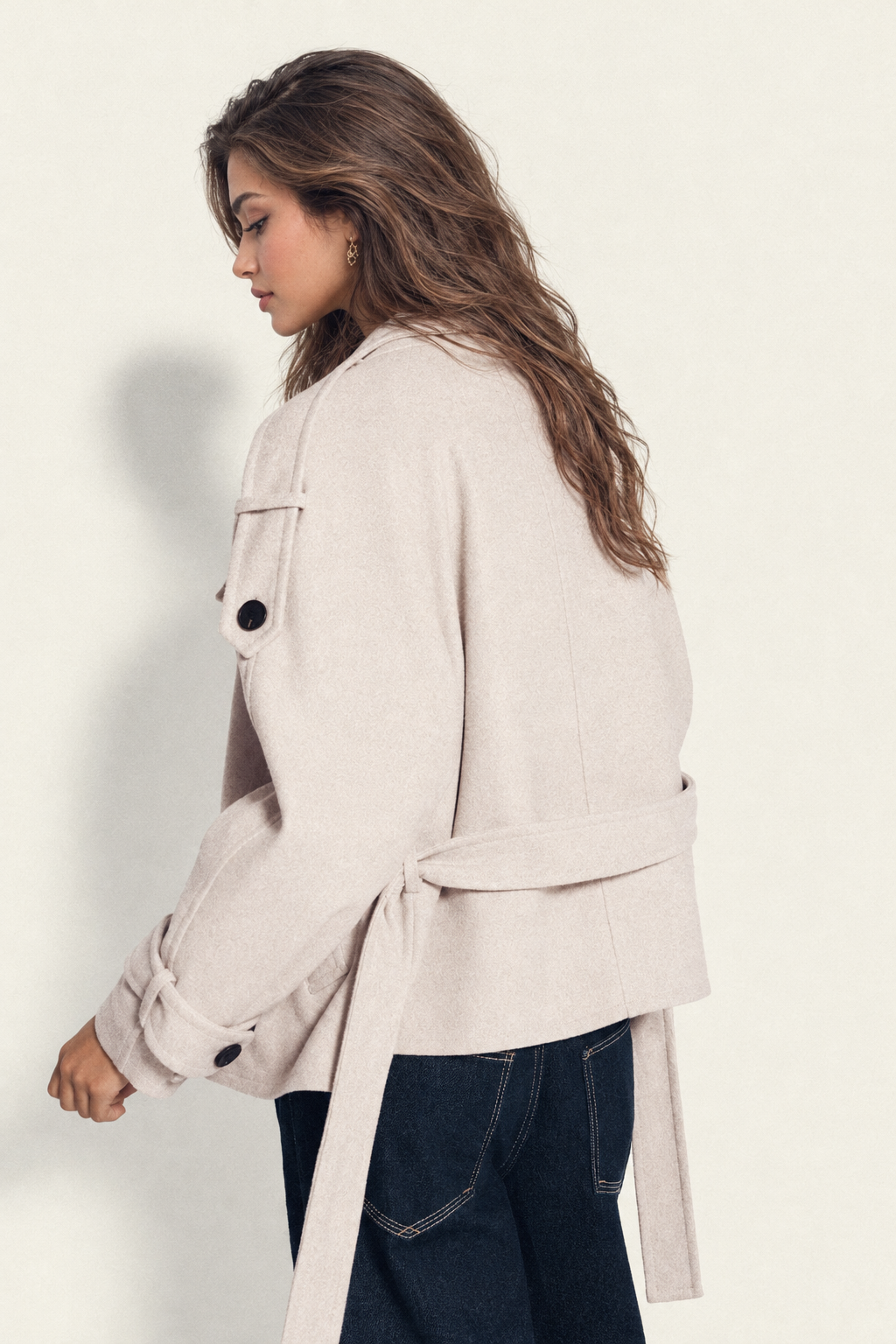 Beige trench coat with tie at waist, back view