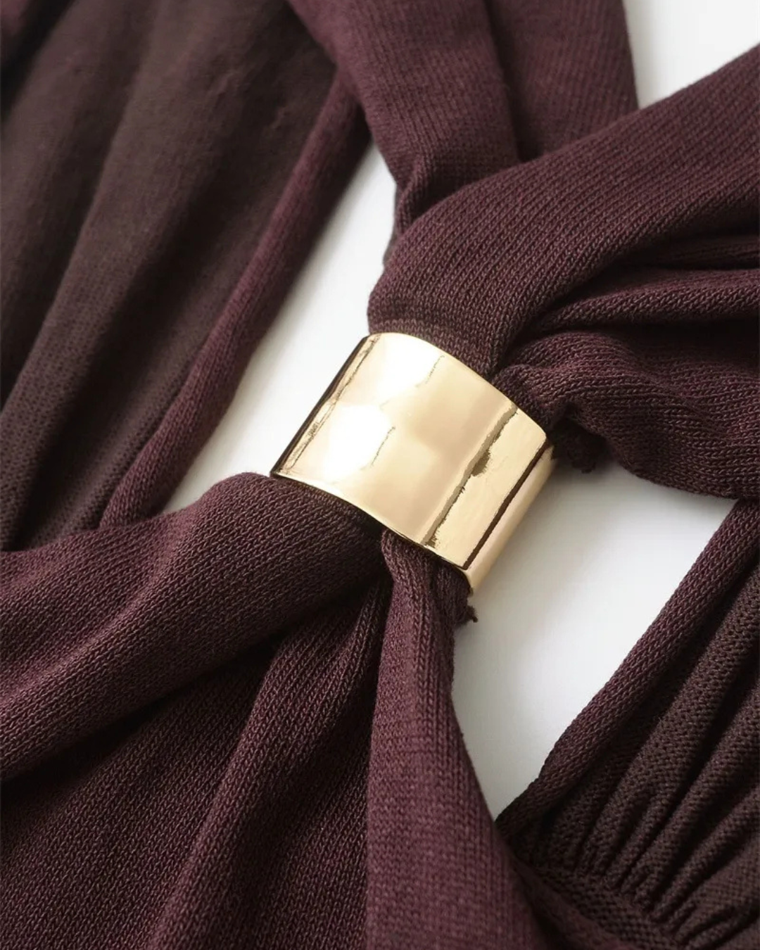 Detail of the gold ring buckle on burgundy halter top