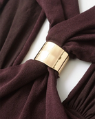 Detail of the gold ring buckle on burgundy halter top