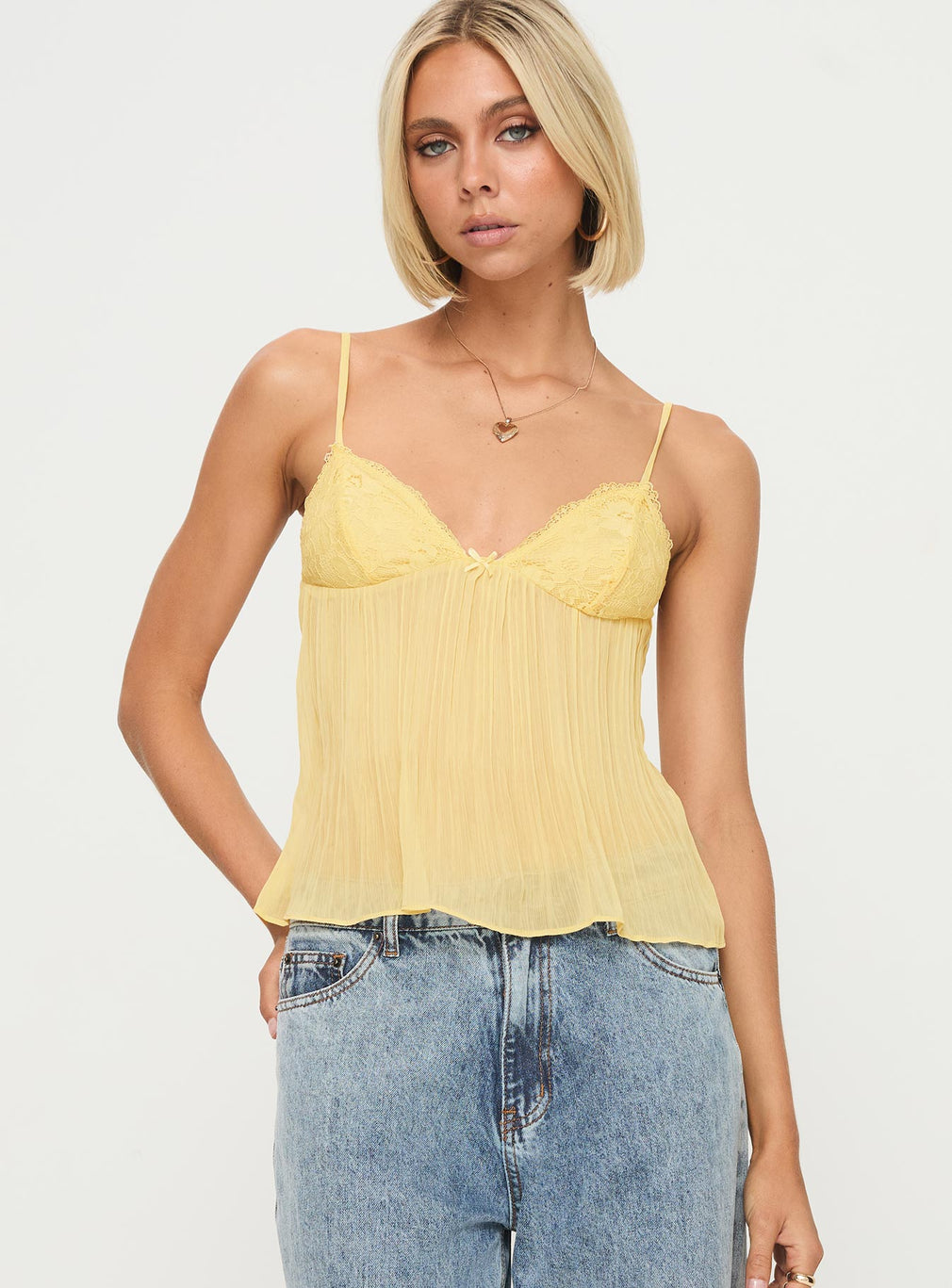 Close-up of the yellow lace bust detail on the cami top