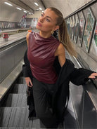 Burgundy faux-leather sleeveless top with high neck, front view on model