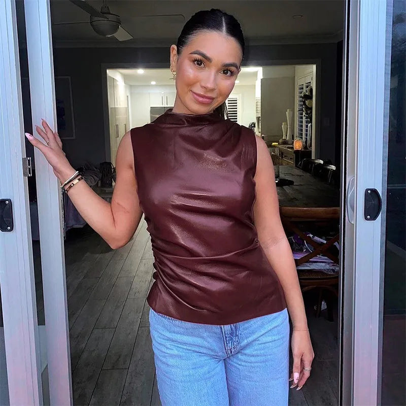 Burgundy faux-leather ruched top styled with jeans, front view on model