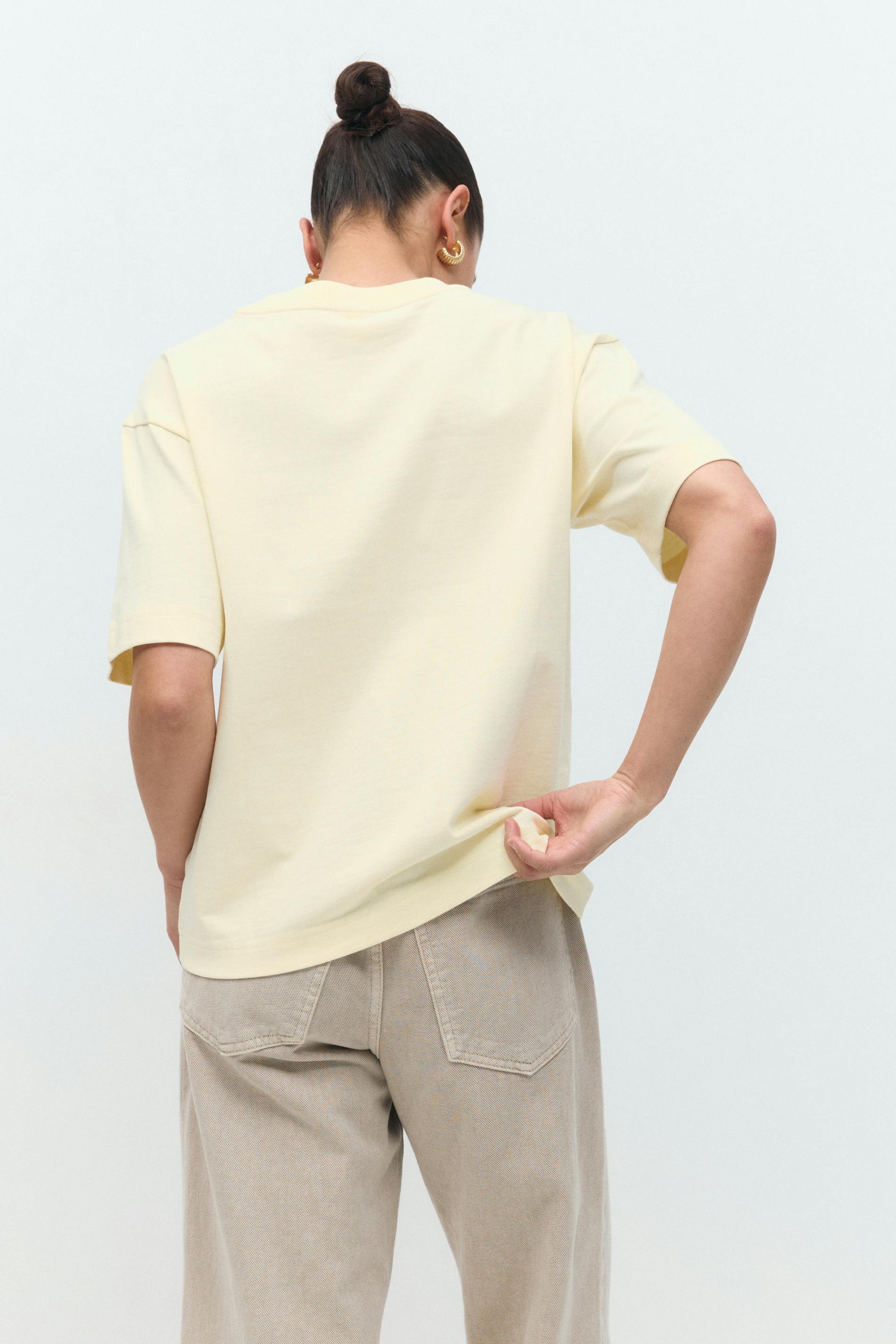 Soft butter yellow cotton t-shirt, back view on model