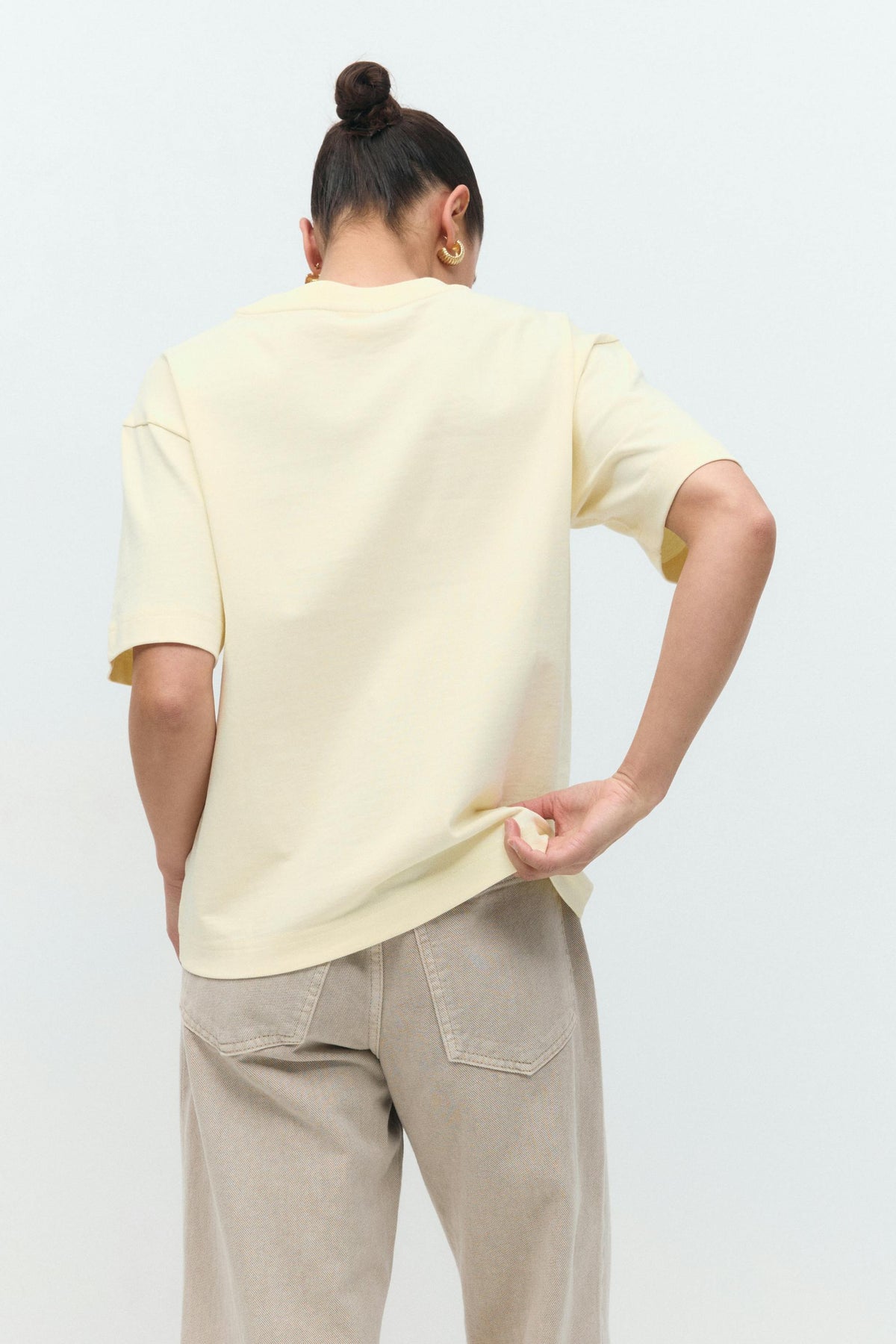 Soft butter yellow cotton t-shirt, back view on model