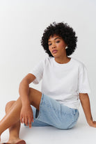 White cotton crew neck t-shirt, seated pose on model