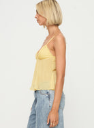 Yellow lace pleated cami top, side view on model