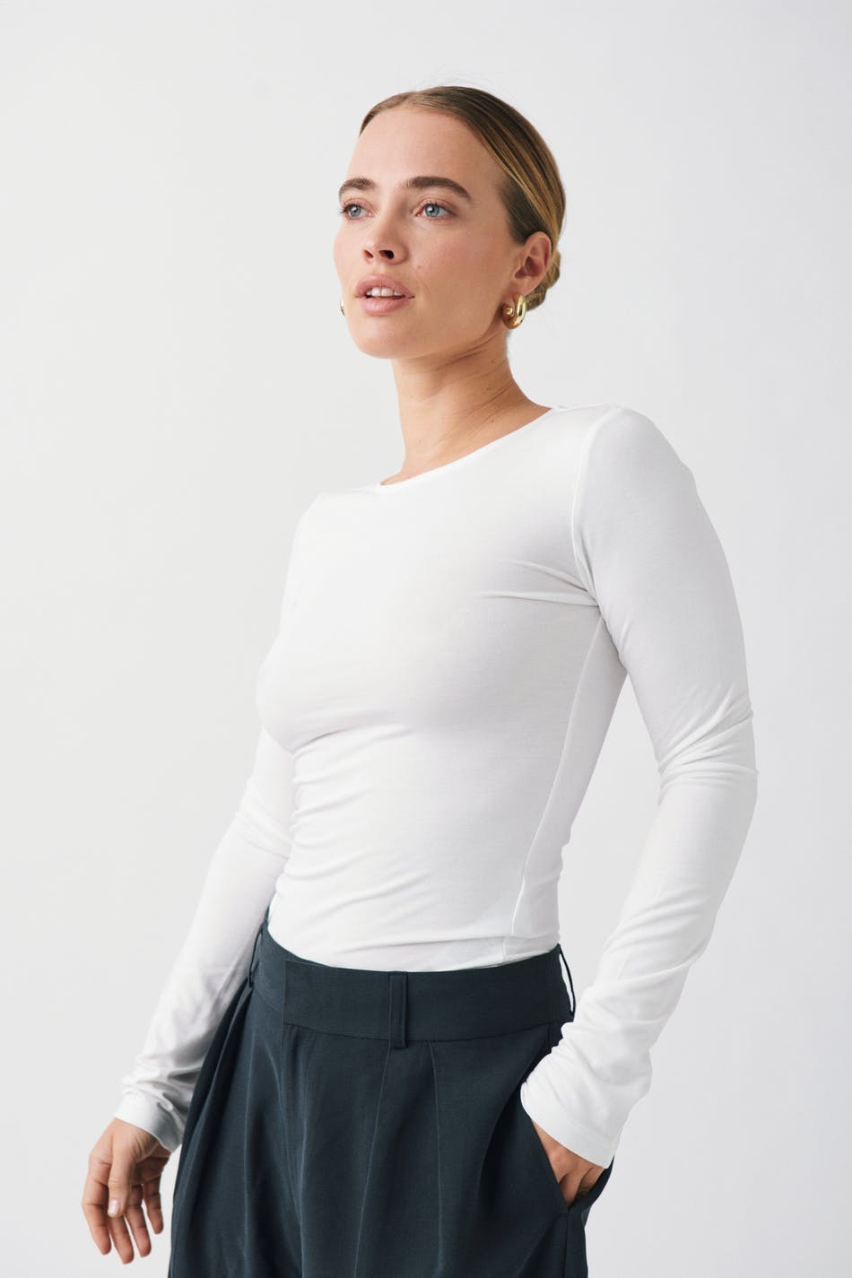 White fitted long sleeve top, front view on model