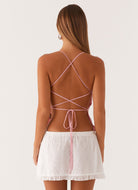 Pink sequin floral cami top, back view with lace-up straps