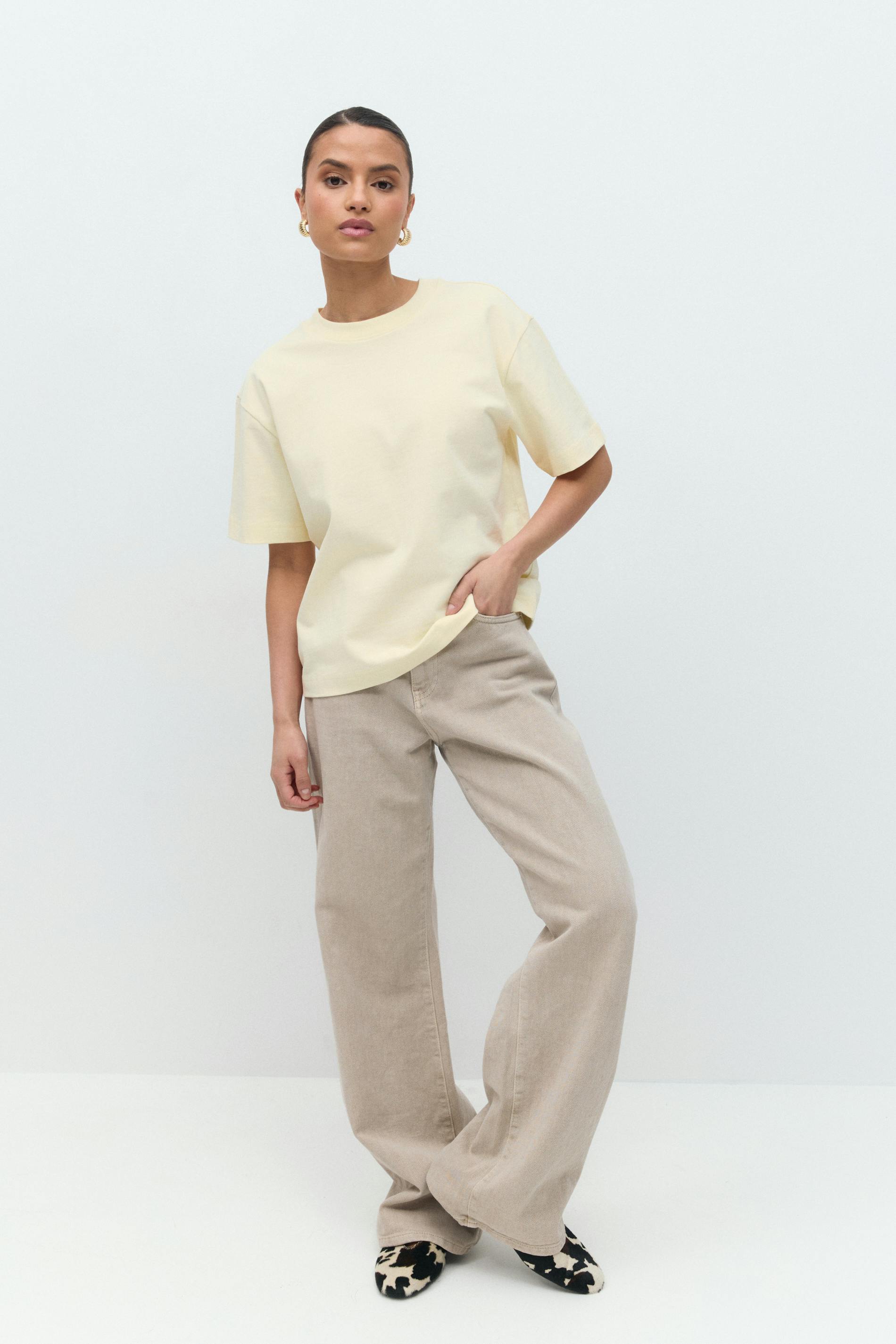 Soft butter yellow cotton t-shirt, full length front view on model