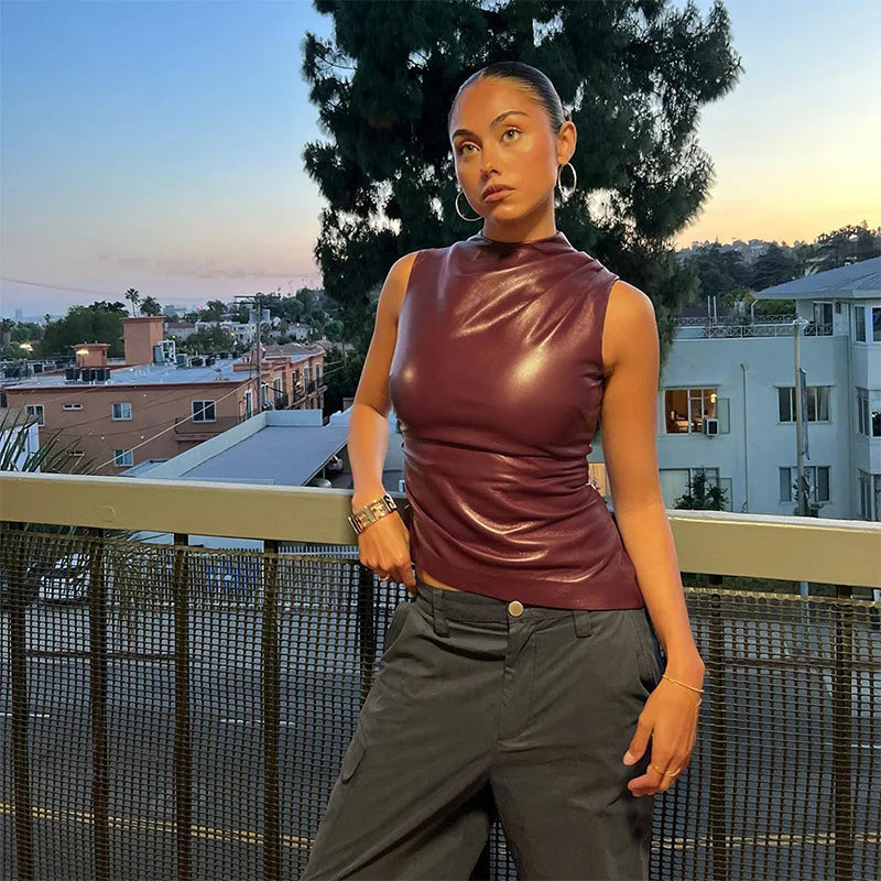 Burgundy faux-leather sleeveless top, outdoor front view on model