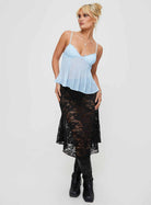 Blue lace cami top with black skirt, full length on model