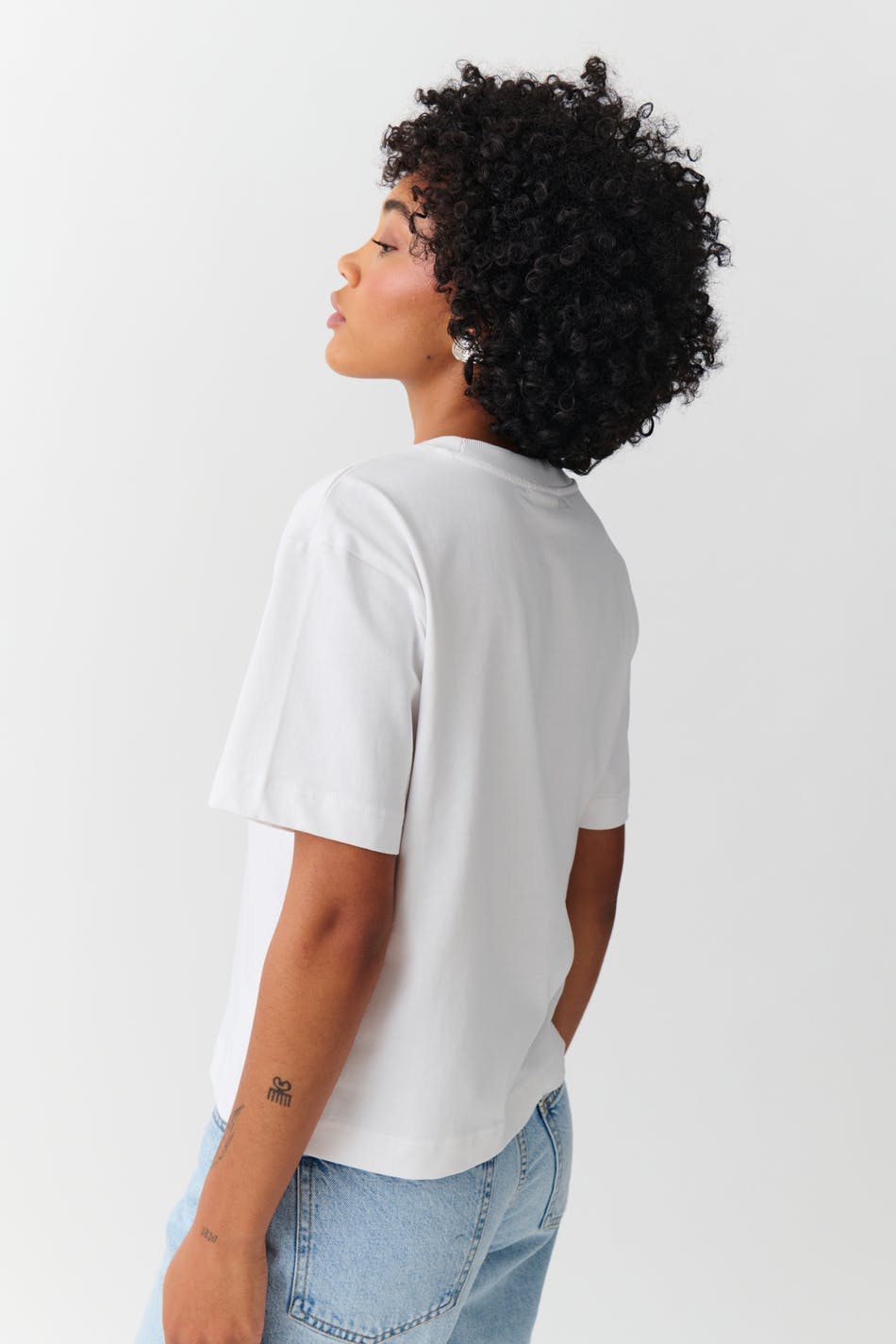 White cotton crew neck t-shirt, back view on model