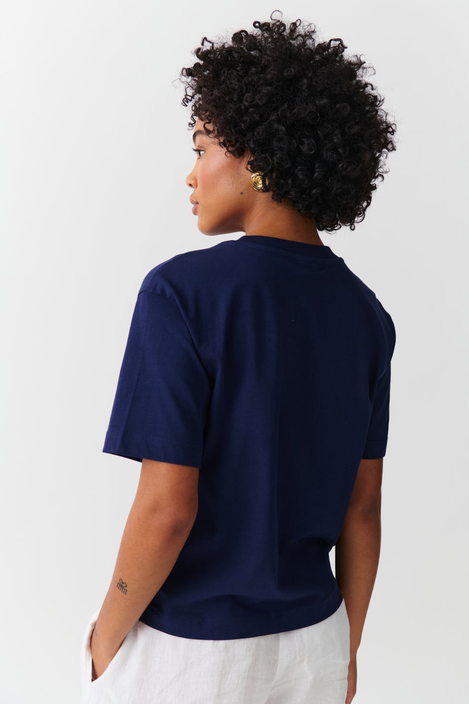 Deep navy cotton crew neck t-shirt, back view on model