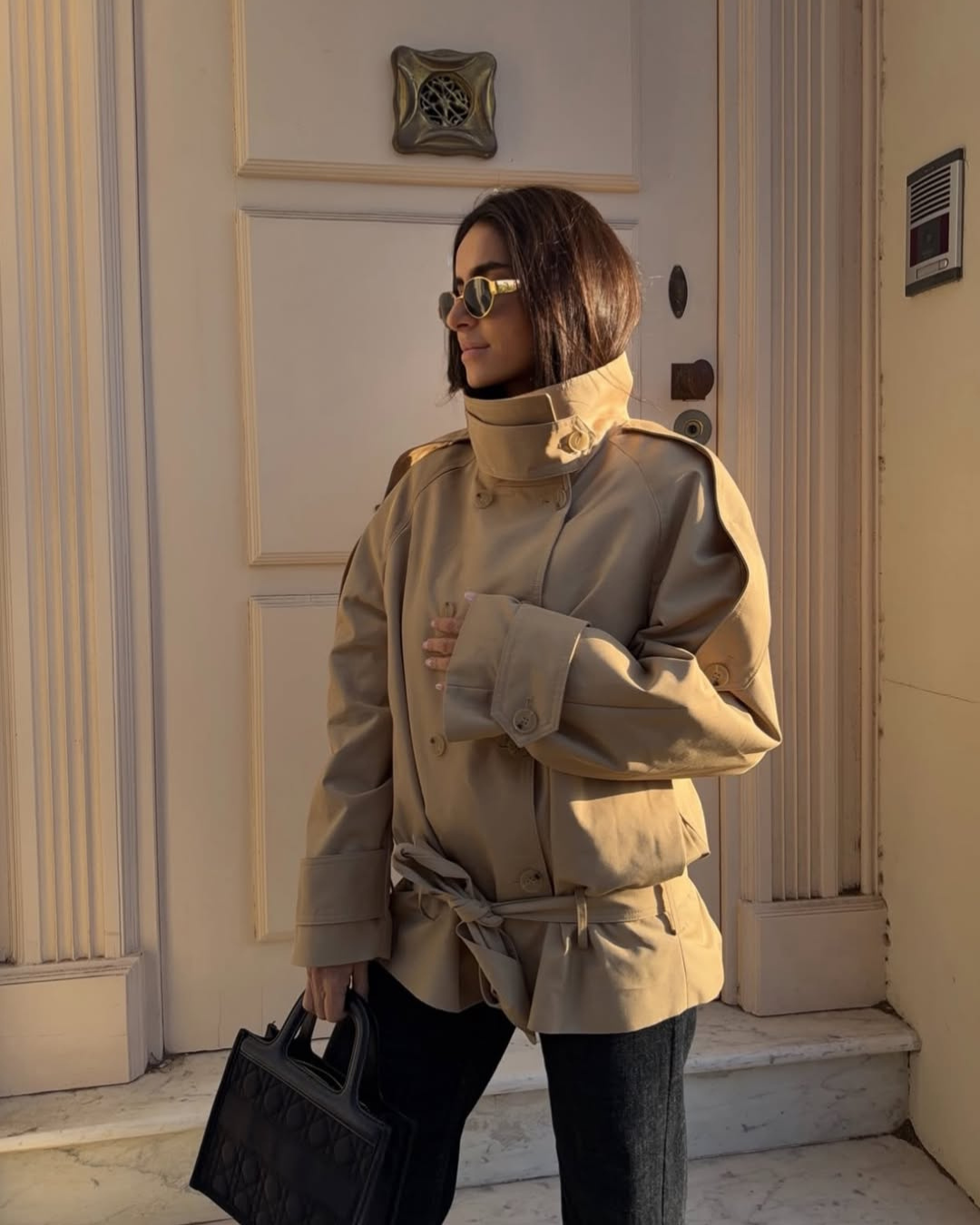 Camel cropped trench coat with belted waist, three-quarter view