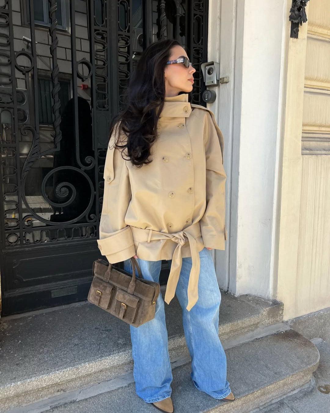 Camel cropped trench coat with belted waist, side view on model